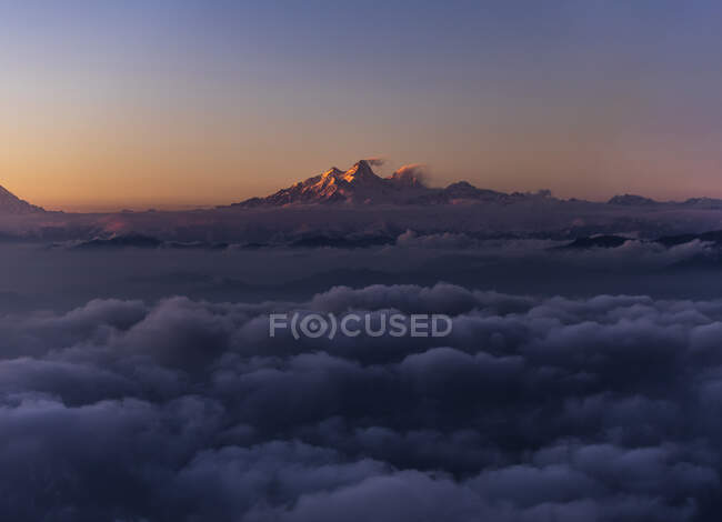 Magnificent drone view of snowy mountain peak illuminated by sunset light in Himalayas in Nepal — Stock Photo