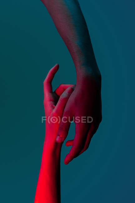 Художнє зображення пари рук, що показують любов під проекторними вогнями — стокове фото