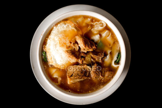 Top view of ramen beef noodles soup on big ceramic bowl — Stock Photo