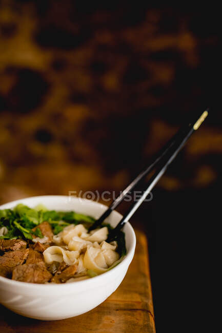 Tasty beef ramen in ceramic white bowl — Stock Photo