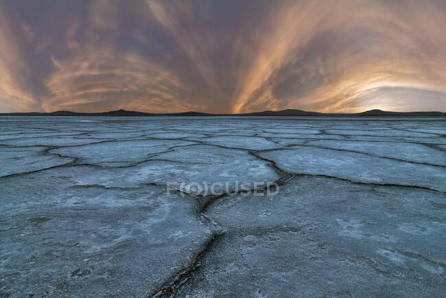 Amazing scenery of salty lagoon with dried rough ground under sundown sky in Penahueca — Stock Photo