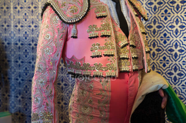 Crop unrecognizable male toreador in traditional costume decorated with embroidery preparing for corrida festival — Stock Photo