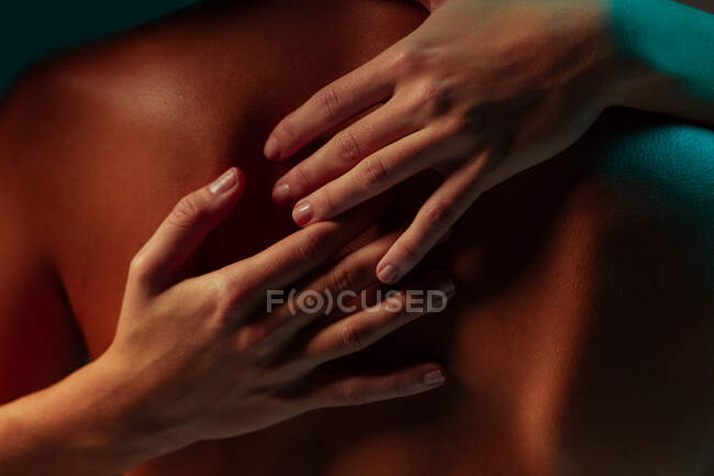 Woman hands embracing a man back — Stock Photo