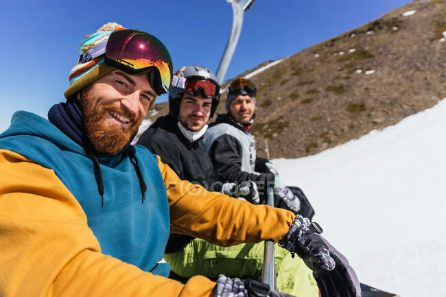 Zufriedene männliche Freunde in Sportbekleidung und Brille blicken in die Kamera gegen die Sierra Nevada in der Provinz Granada Spanien — Stockfoto