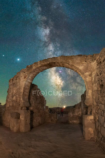 Low angle of aged arched passage of medieval castle under glowing Milky Way in night sky — Stock Photo