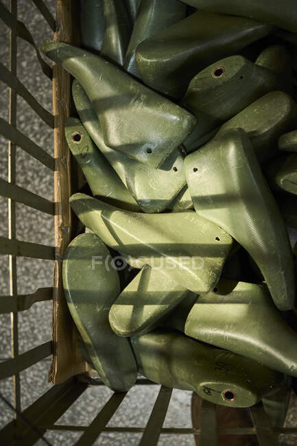 Detail of shoes molds in a container at Chinese shoes factory — Stock Photo
