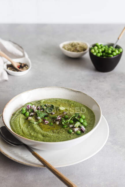 Delicious peas cream over concrete white table — Stock Photo