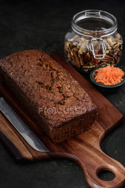 From above view of a carrot cake next to the ingredients on a rustic background — Stock Photo