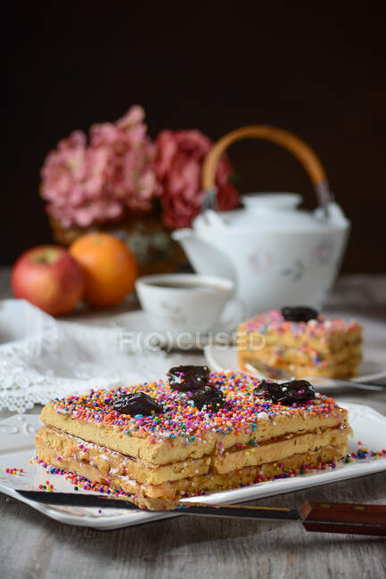 Delicious traditional Turron de Dona Pepa dessert with colorful dragee served on plate on table — Stock Photo