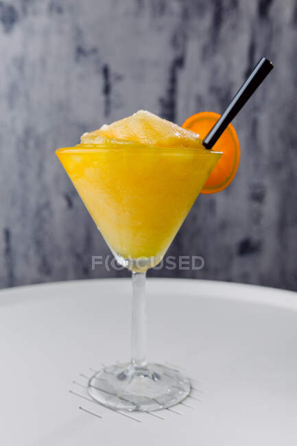 Glass of sweet Daikiri Maracuya cocktail made of rum lime juice and sugar with passion fruit on table — Stock Photo