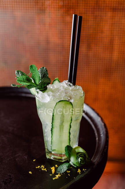Cold Cucumber Splash cocktail consisting of apple and lemon juice pear puree garnished with mint leaves — Stock Photo
