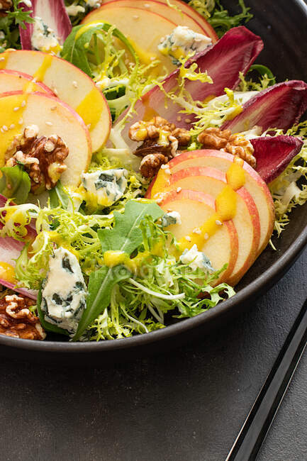From above colorful delicious salad with endives, apple and roquefort cheese on dark background — Stock Photo