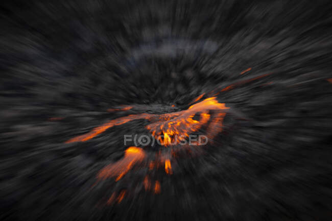From above soft focus of fiery lava flowing through gray terrain in Iceland — Stock Photo