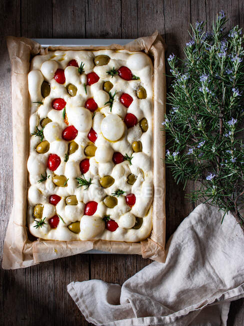 From above dough for delicious focaccia with sun dried tomatoes — Stock Photo