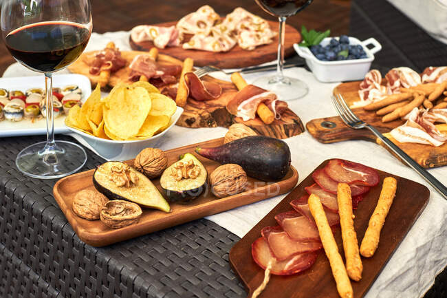 Vista dall'alto dell'appetitoso assortimento di antipasti serviti con piatti sul tavolo in terrazza — Foto stock