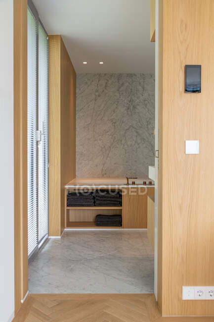 Doorway of modern bathroom with wooden walls in luxury apartment with minimalistic design — Stock Photo
