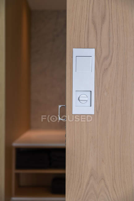 Chrome details on wooden sliding door of spacious built in closet in contemporary house in daylight — Stock Photo