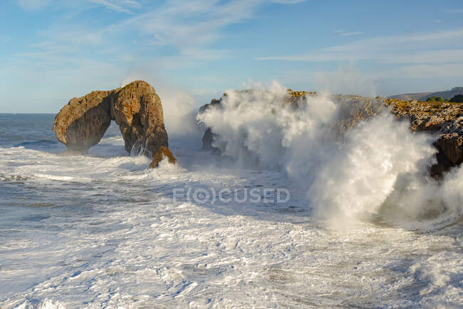 From above spectacular scenery of powerful foamy sea waves splashing near rough rocky cliffs in Castro de las Gaviotas Asturias Spain — Stock Photo