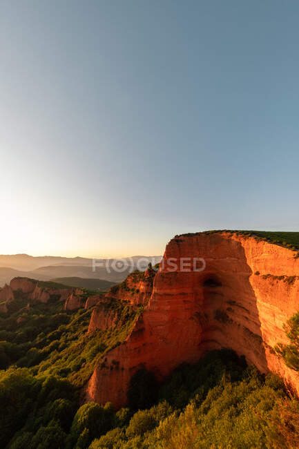 Scenic view of rough mounts with moss under cloudy blue sky on sunny day — Stock Photo