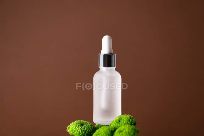 Close-up of a glass bottle with serum — Stock Photo