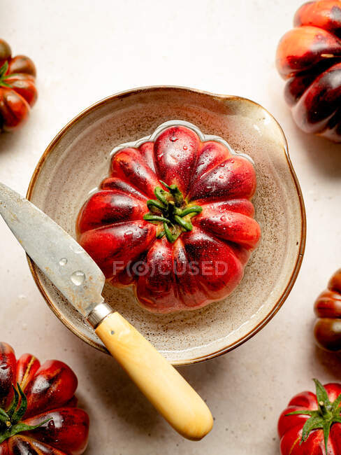 Top view closeup of several red tomatoes on a white table — Stock Photo