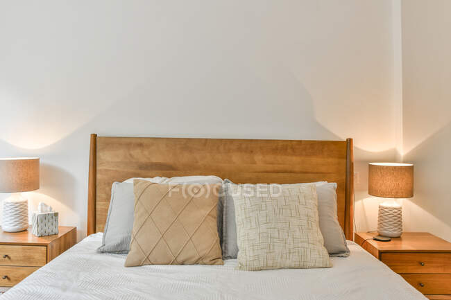 Interior of modern bedroom with comfortable bed in new apartment — Stock Photo