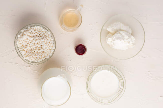 Top view of various ingredients for preparing white hot chocolate arranged on white background in studio — Stock Photo