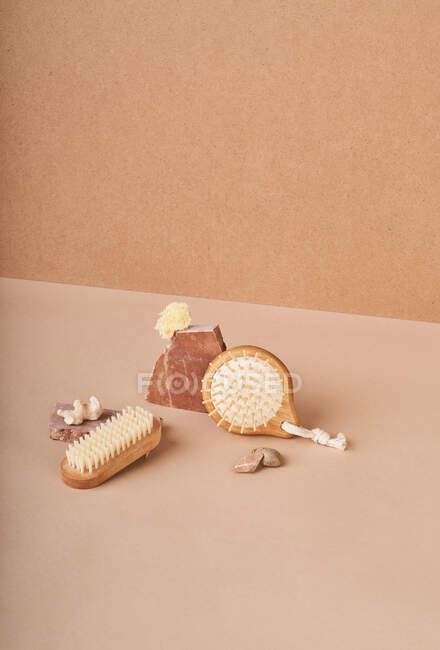 From above of eco friendly brushes and natural soap bars with pumice stone and mineral on beige background — Stock Photo