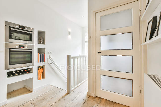 Interior of hall with modern wine cooler and staircase in house designed in minimal style — Stock Photo