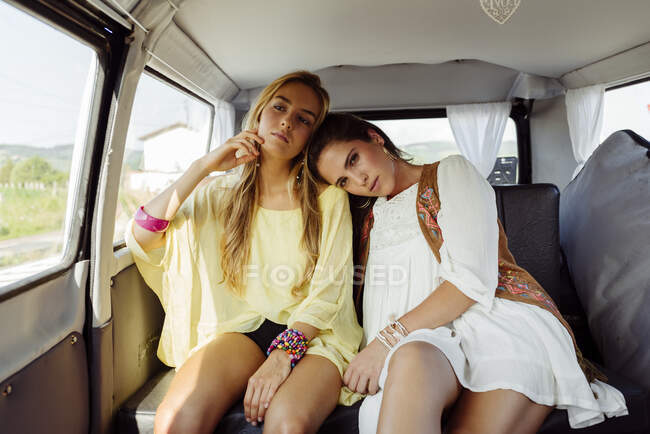 Girls on a trip in a rural area sitting inside a van while they look at camera — Stock Photo