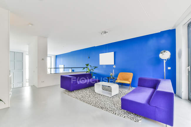 Kreative Gestaltung des geräumigen Zimmers mit Sofas und Stuhl am Teppichfenster im Haus — Stockfoto