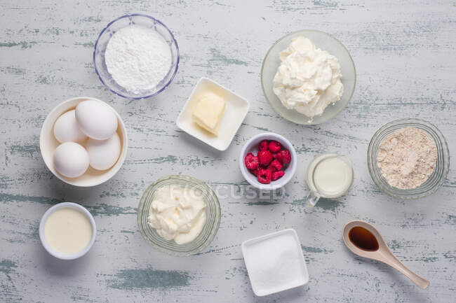 Top view of various ingredients for low carbohydrates keto crepes with raspberries and erythritol sweetener placed on table in light kitchen — Stock Photo