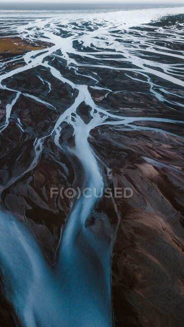 Picturesque aerial view of curvy rivers flowing through wild mountainous terrain in Iceland — Stock Photo