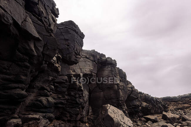 Scenery view of volcano stones under cloudy sky in Guincho Volcano in Golfo Yaiza Lanzarote Canary Islands Spain — Stock Photo