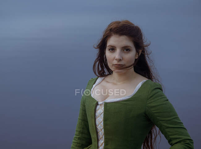 Portrait of dreamy female in old fashioned clothes in misty weather — Stock Photo