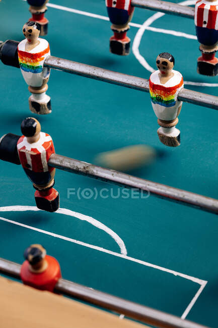 High angle of detail of retro table soccer with wooden miniature figurines of players on metal bars — Stock Photo