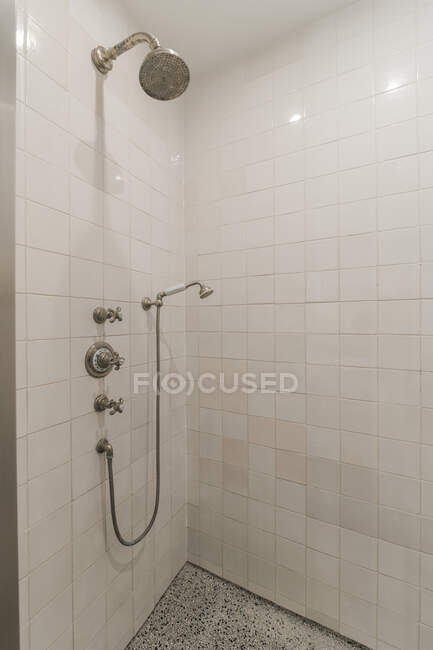 Modern minimalist style interior design of bathroom with white tiled walls and shower unit in corner — Stock Photo