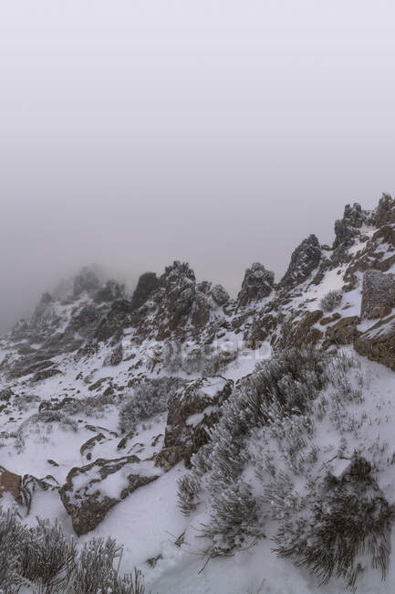 Paesaggio di montagne innevate coperte di nuvole. Parco nazionale Picos de Europa, Spagna — Foto stock