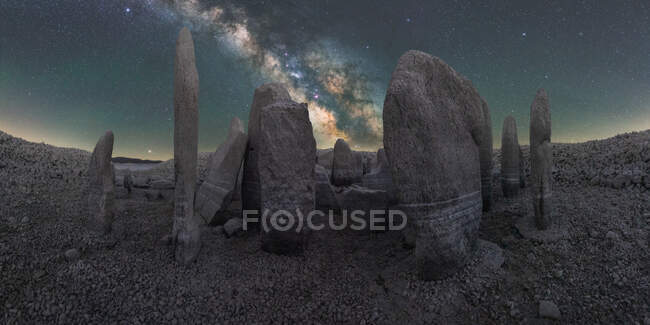 Picturesque view of Spanish Stonehenge on rough terrain under sunset sky with galaxy in Caceres Spain — Stock Photo