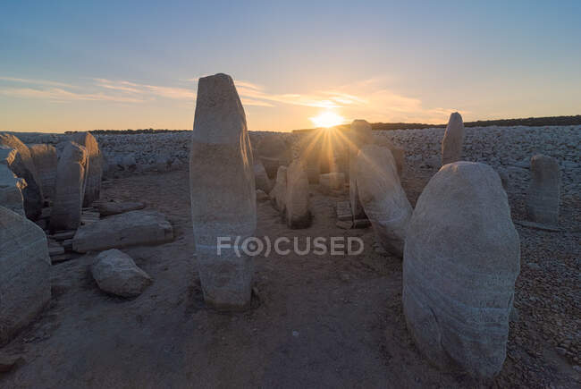 Dolmen of Guadalperal with ancient megalithic monuments on dry land under glowing sun in twilight in Caceres Spain — Stock Photo