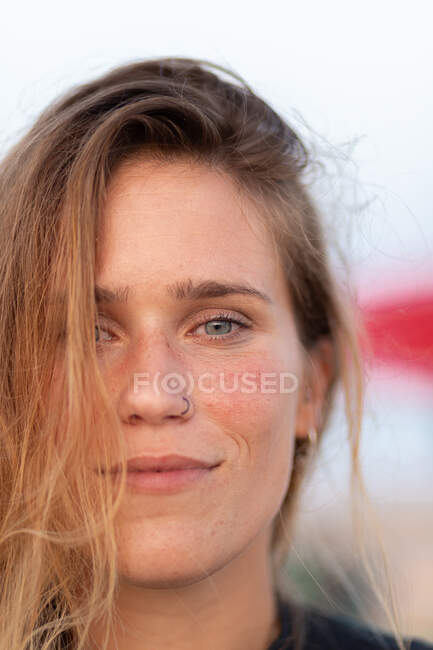 Serene female with wet hair in summer evening and looking at camera — Stock Photo