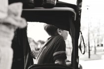 Boy sitting in baby carriage — Stock Photo