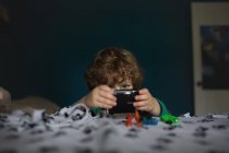 Cute little boy playing with camera — Stock Photo