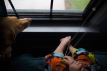 Little boy and dog sitting near window — Stock Photo