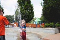 Boys playing in fountain — Stock Photo