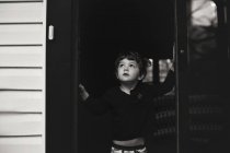 Little boy standing in the doorway — Stock Photo