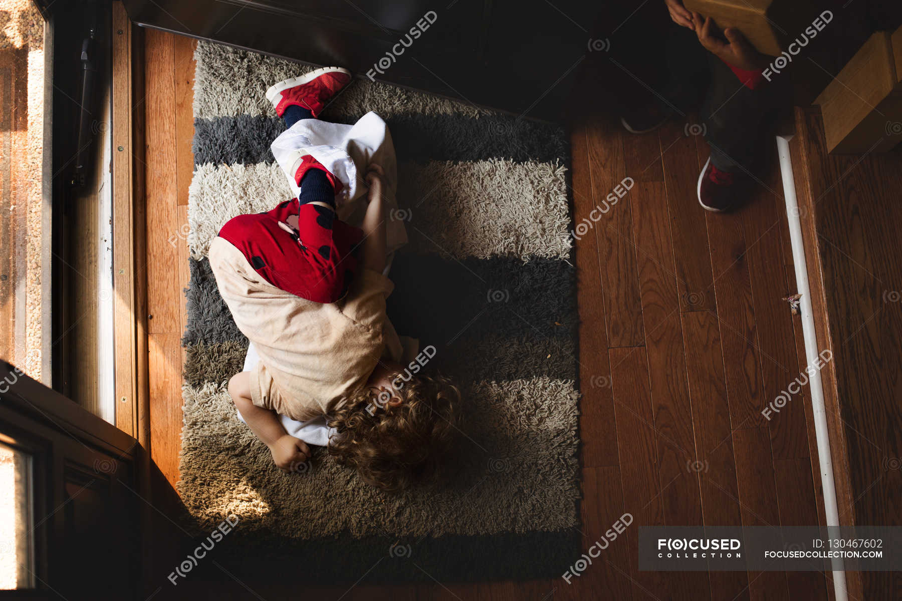 Boy lying on the carpet — relax, fun - Stock Photo | #130467602