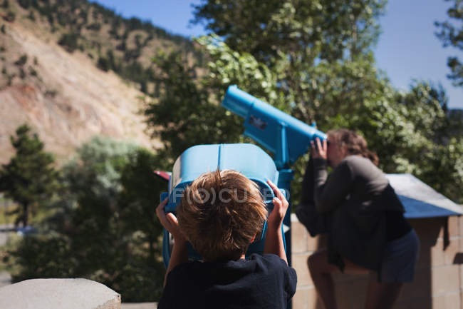 Little boy looking in binoculars — Stock Photo