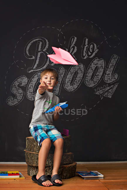 Smiling little boy with paper plane — Stock Photo