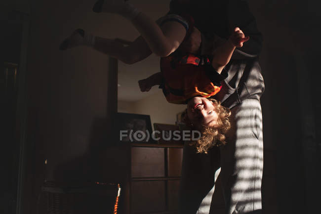 Dad holding son upside down — Stock Photo